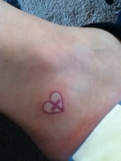 Red Cross In White Heart Tattoo On Ankle