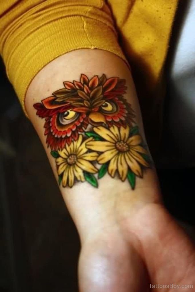 Red Ink Owl Head And Realistic Sunflower Tattoos On Wrist'