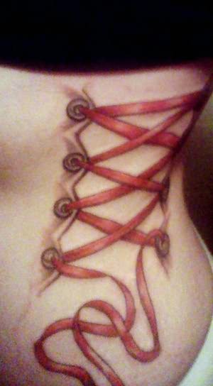 Red Ribbon Corset Tattoo On Girl Side Rib