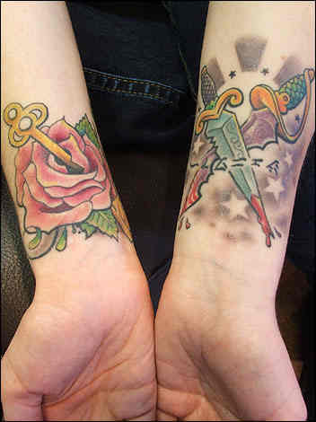 Red Rose Flower And Dagger Tattoos On Wrists For Girls