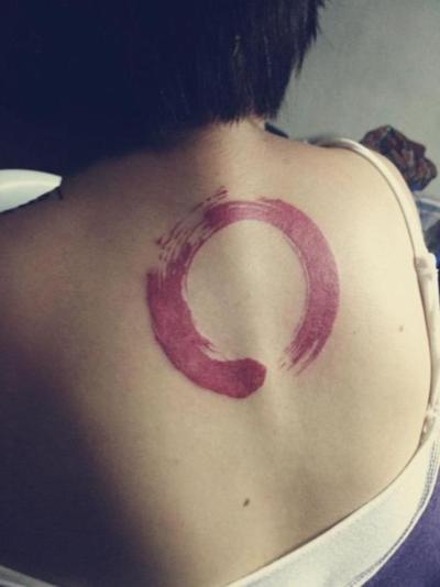 Red Zen Circle Tattoo On Girl Upper Back