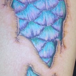 Ripped Skin Mermaid Scale Tattoo Idea