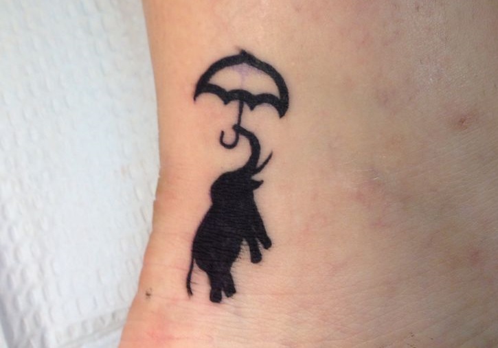 Simple Silhouette Elephant With Umbrella Tattoo on Ankle