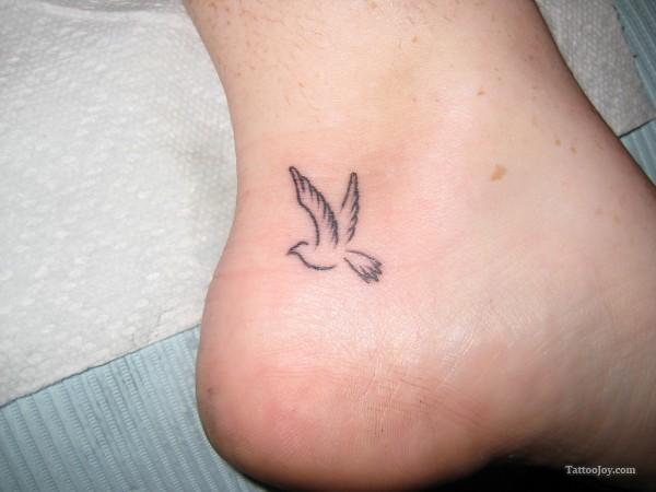 Small Outline Flying Bird Ankle Tattoo
