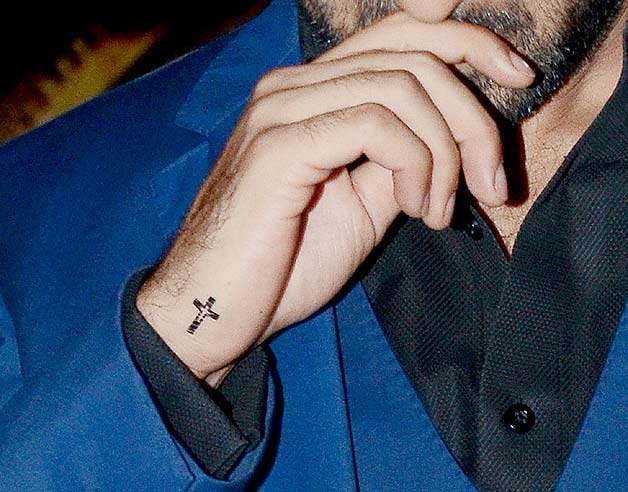 Tiny Cross Tattoo On Man Side Wrist
