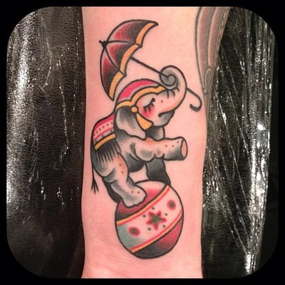 Traditional Circus Elephant On Ball With Umbrella Tattoo Design For Forearm