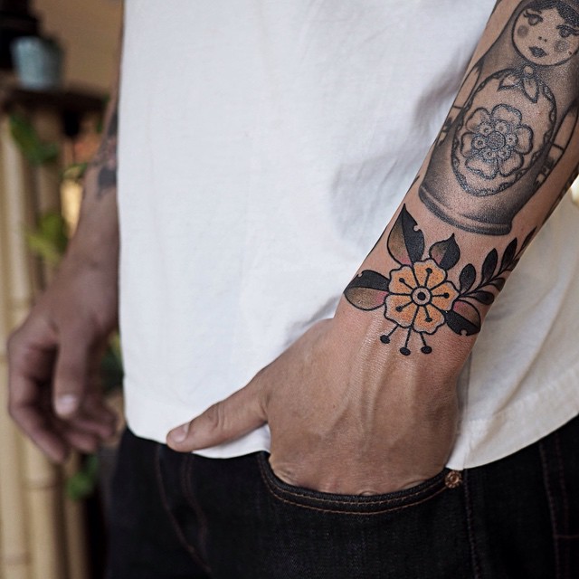 Traditional Flower Tattoo On Left Wrist