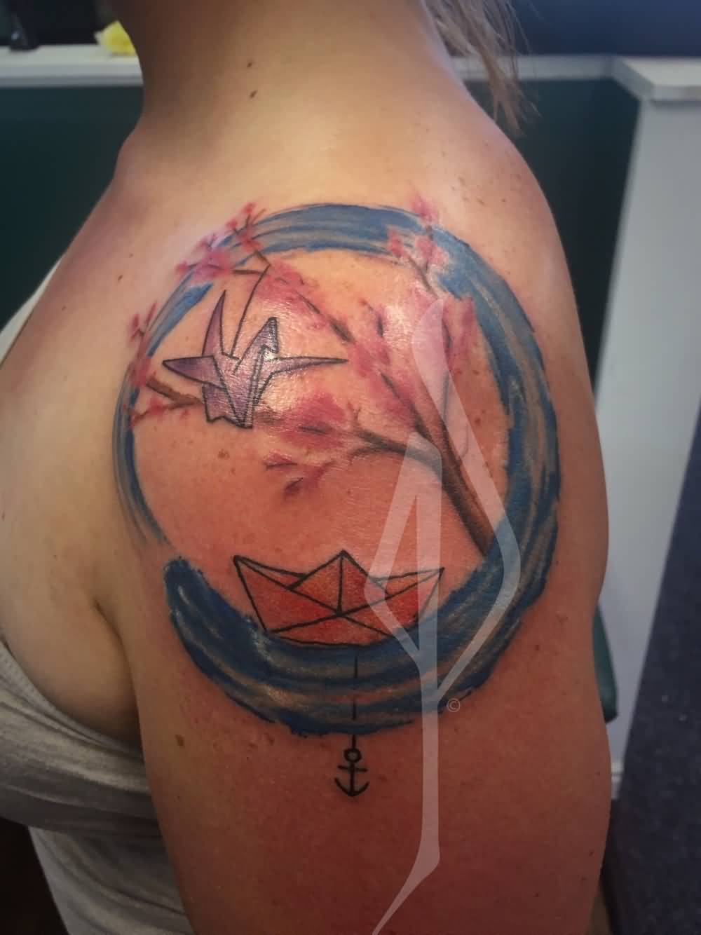 Watercolor Zen Circle With Paper Boat And Bird Tattoo On Girl Left Shoulder By Jon Poulson