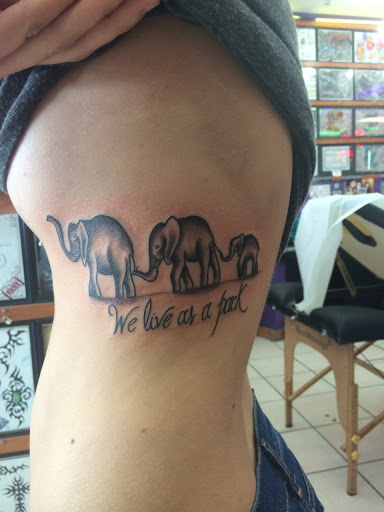 We Live As A Park - Black Ink Elephant Family Tattoo On Side Rib