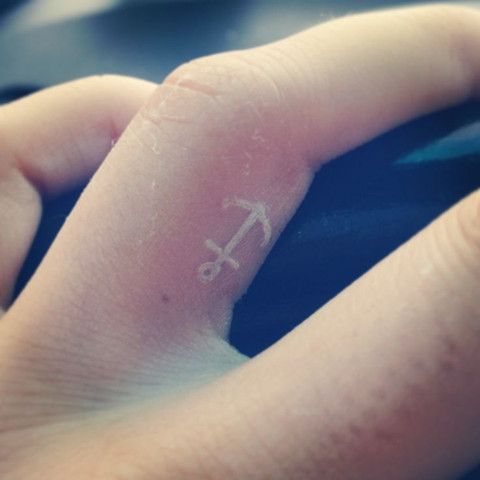 White Anchor Tattoo On Side Finger