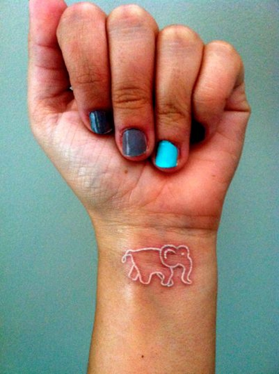 White Ink Elephant Tattoo On Girl Right Wrist