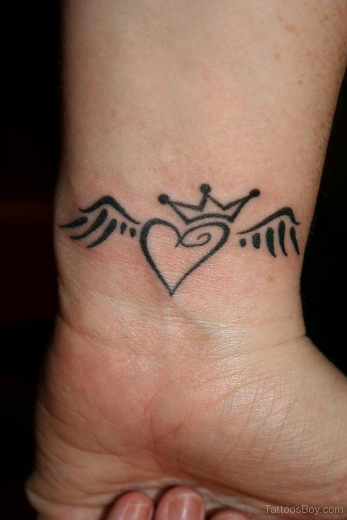 Winged Heart With Crown Tattoo On Wrist
