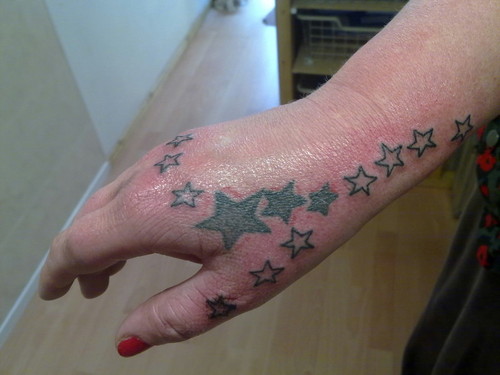 Woman With Right Hand Stars Tattoo