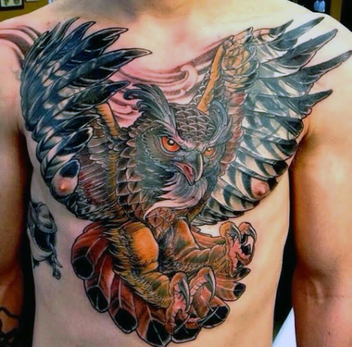 Amazing Colorful Flying Owl Tattoo On Man Chest