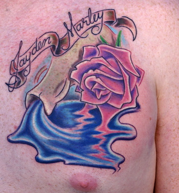 Aquarius Zodiac Sign With Flower And Banner Tattoo On Man Left Chest