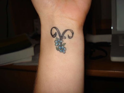 Aries Zodiac Sign With Flowers Tattoo On Wrist