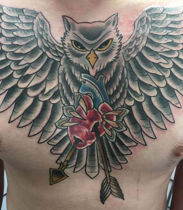 Arrow In Real Heart With Flying Owl Tattoo On Man Chest