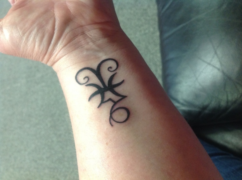 Attractive Black Zodiac Sign Tattoo On Left Wrist
