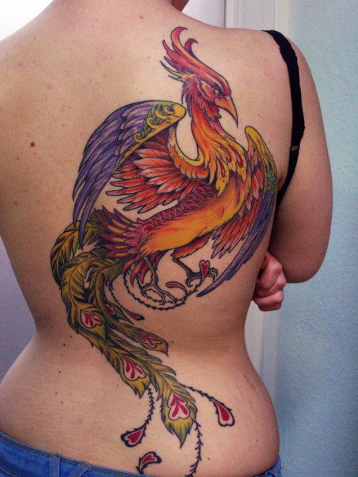 Attractive Colorful Flying Phoenix Bird Tattoo On Full Back