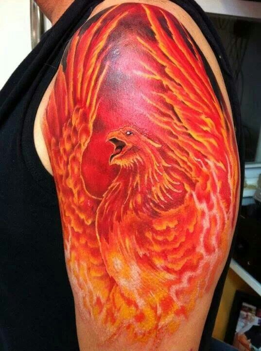 Attractive Flaming Flying Phoenix Tattoo On Left Upper Arm