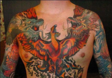 Attractive Flaming Phoenix With Dragons Tattoo On Man Chest
