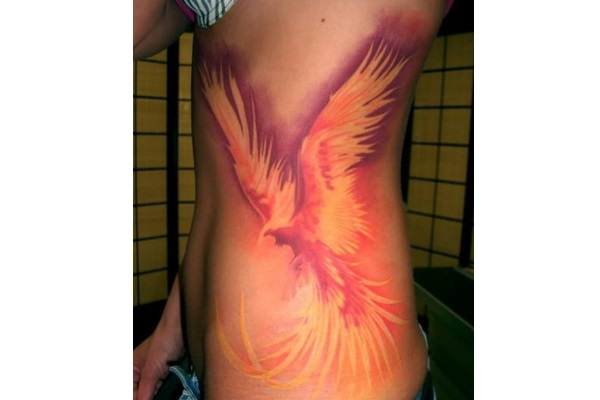 Attractive Flying Phoenix Tattoo On Girl Left Side Rib