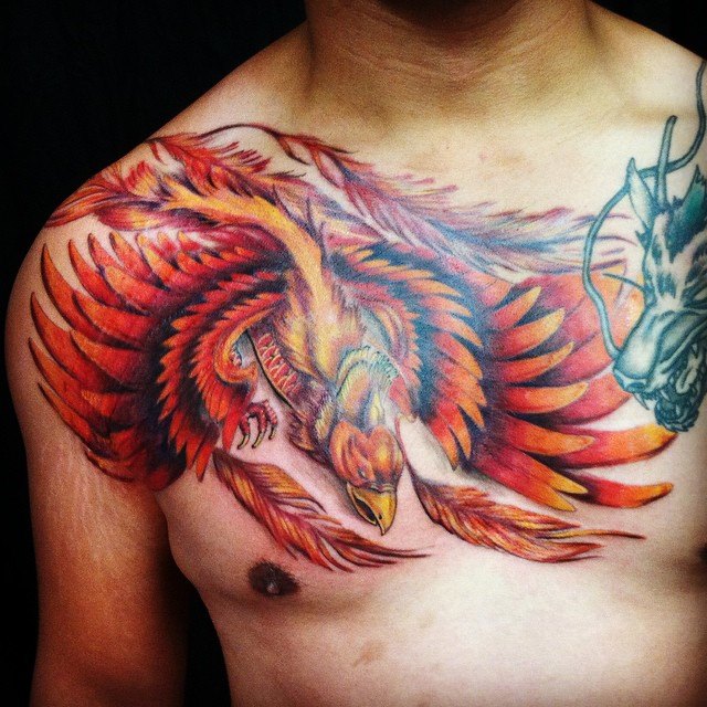 Attractive Phoenix With Dragon Tattoo On Man Chest