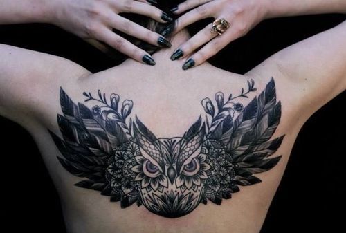 Awesome Black Ink Flying Owl Tattoo On Girl Upper Back By French Artist Dodie