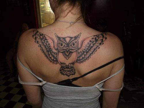 Awesome Black Ink Flying Owl Tattoo On Girl Upper Back