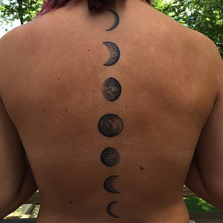 Awesome Black Ink Phases Of The Moon Tattoo On Spine