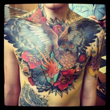 Awesome Colorful Flying Owl Tattoo On Man Chest