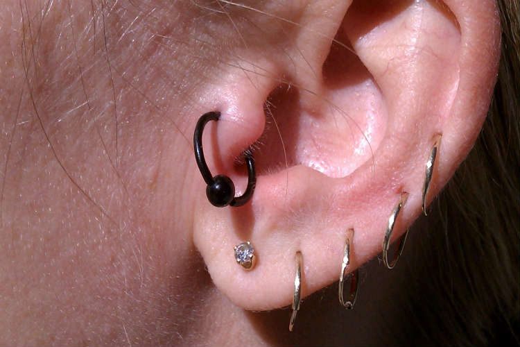 Awesome Ear Lobe And Tragus Piercing With Black Bead Ring