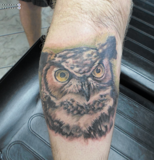 Awesome Owl Face Tattoo On Right Leg Calf