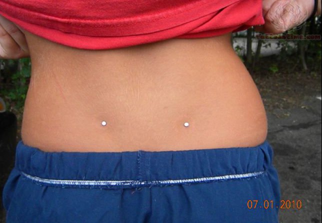 Back Dimple Piercing With White Dermals