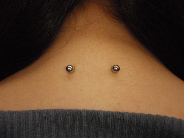 Back Neck Piercing Idea For Girls With Silver Barbell