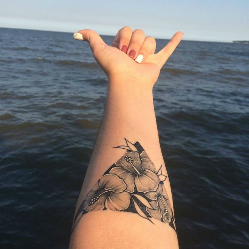 Black And Grey Flowers In Upside Down Triangle Tattoo On Girl Left Forearm
