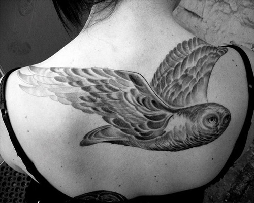 Black And Grey Flying Owl Tattoo On Girl Upper Back