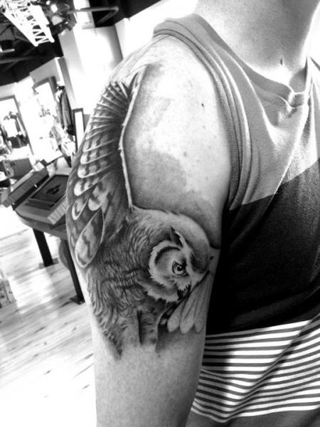 Black And Grey Flying Owl Tattoo On Man Right Half Sleeve