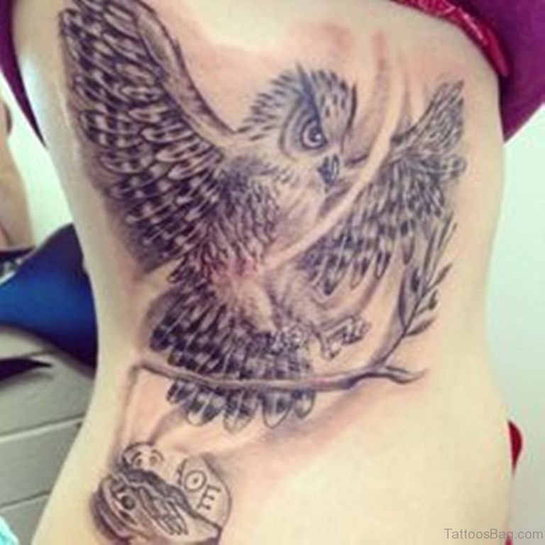 Black And Grey Flying Owl Tattoo On Right Side Rib