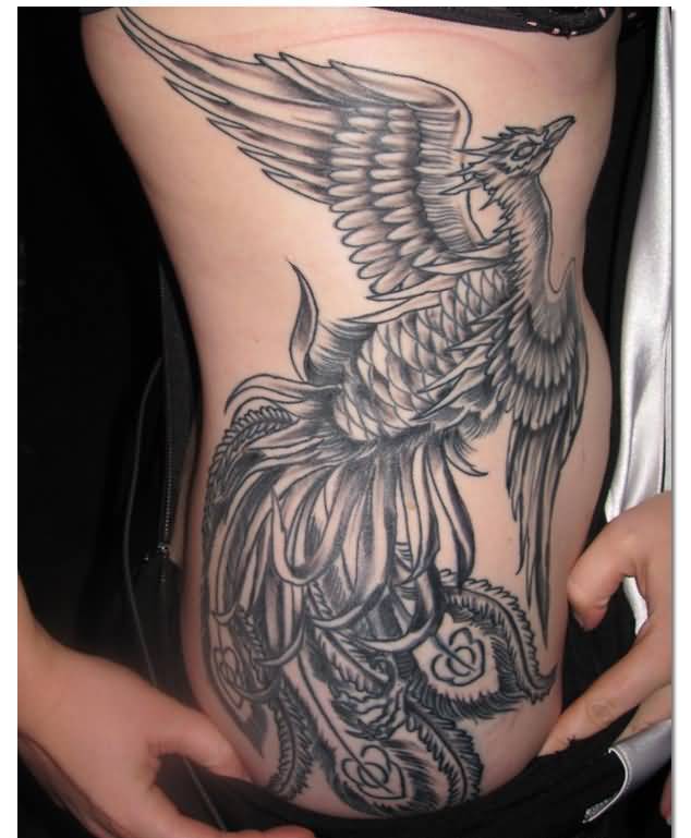 Black And Grey Flying Phoenix Bird Tattoo On Girl Right Side Rib
