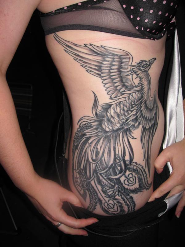 Black And Grey Flying Phoenix Tattoo On Girl Right Side Rib