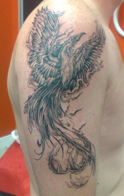 Black And Grey Flying Phoenix Tattoo On Man Right Half Sleeve