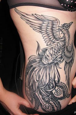 Black And Grey Rising Phoenix From The Ashes Tattoo On Girl Right Side Rib