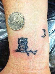 Black And Grey Small Owl On Branch Tattoo On Wrist