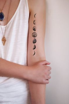 Black And Grey Small Phases Of The Moon Tattoo On Left Bicep