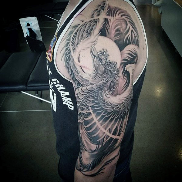 Black And White Rising Phoenix From The Ashes Tattoo On Man Left Half Sleeve