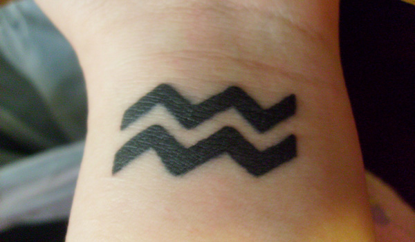 Black Aquarius Zodiac Sign Tattoo Design For Wrist