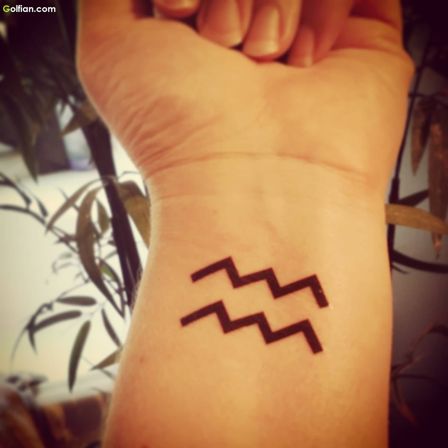 Black Aquarius Zodiac Sign Tattoo On Left Wrist