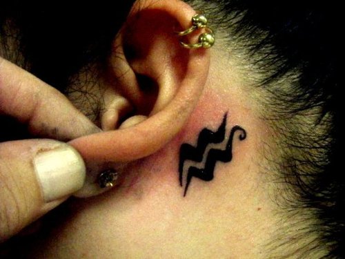 Black Ink Aquarius Zodiac Sign Tattoo On Left Behind The Ear
