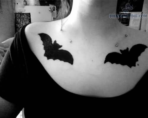 Black Ink Bat Tattoos and Clavicle Piercing With Silver Barbells